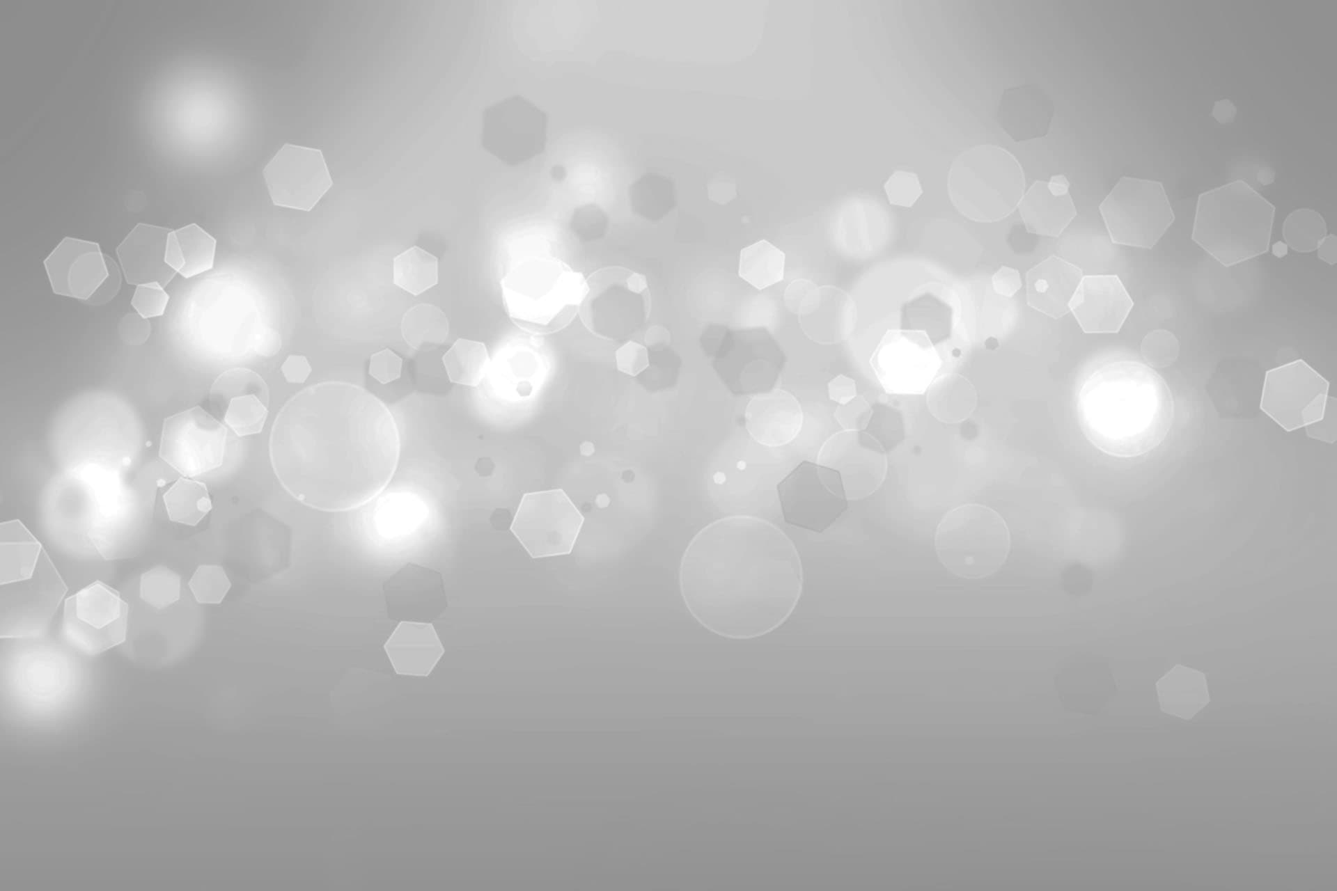 Fondo difuso con destellos de luz y formas hexagonales, representando un ambiente moderno y profesional en el contexto de La Clínica Dental Guadalajara.